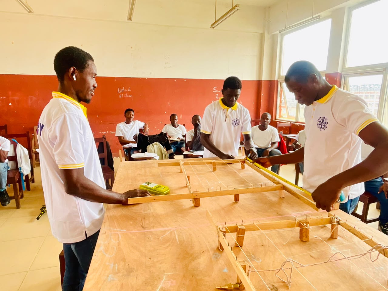Trainees working together on a reinforcement layout in class
